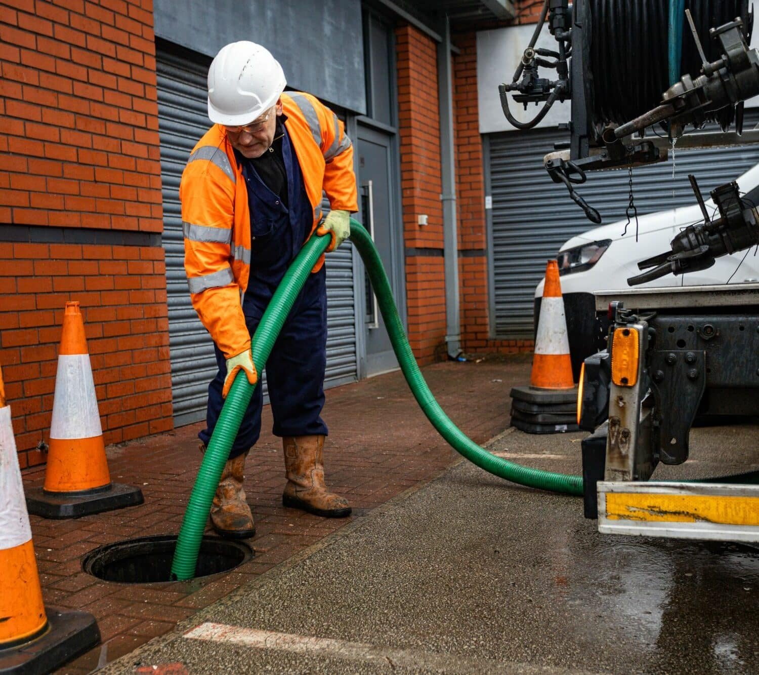 Engineer clearing a blocked external drain